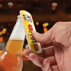 A drink bottle opener in yellow and silver being used to open a glass bottle with beer. The image includes a logo.