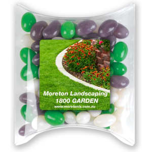 A pillow pack filled with green, purple, and white jelly beans, featuring a logo on the front.