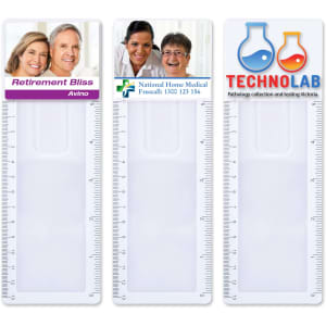 A clear, plastic bookmark magnifier ruler featuring three sections with varying designs and a logo on each section.