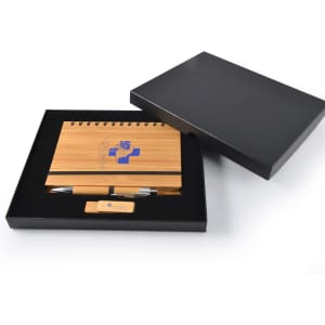 A bamboo notebook, wooden USB, and pen neatly presented in a black gift box. Features a logo on the notebook.