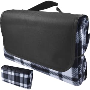 A black and white checkered picnic blanket, folded with a carrying handle. It features a sleek black exterior.
