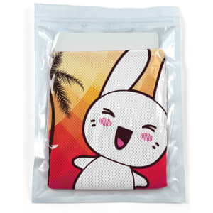 A cooling towel packaged in a clear pouch featuring a cartoon rabbit design and a colorful background with palm trees.