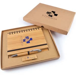A bamboo notepad with a pen in a cardboard gift box, featuring a logo on the items and box.