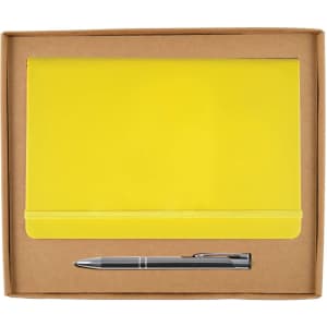 A yellow notebook with an elastic band and a silver pen are presented in a cardboard gift box.