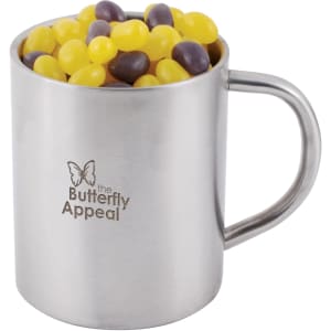 A silver mug filled with colourful jelly beans in yellow and purple, featuring a logo on the side.