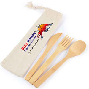 A bamboo cutlery set in a cream calico pouch, featuring a knife, fork, and spoon. The pouch has a logo.