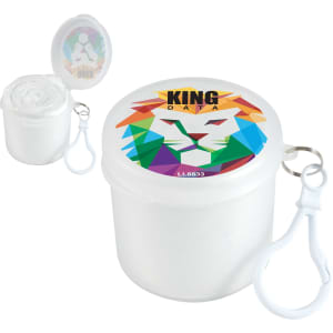 A white container with a colourful lion design on the lid, holding a roll of material and featuring a clip attachment.