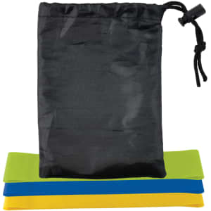 Three resistance bands in green, blue, and yellow stacked beneath a black storage pouch with a drawstring.