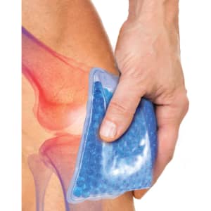 A blue gel bead hot and cold pack is held against a knee, showcasing its flexible design and soothing texture.