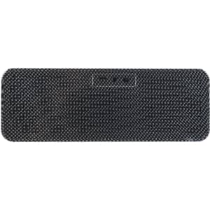 A black speaker and inductive charger with a textured surface, featuring a logo and multiple ports.