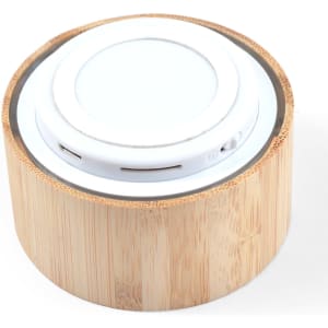 A bamboo Bluetooth speaker featuring a round, sleek design with a white speaker top.