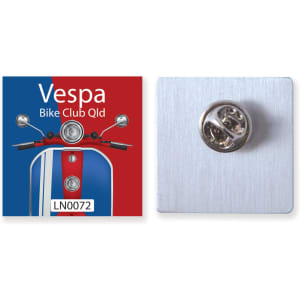 A 25mm aluminium badge featuring a colourful Vespa design and a metal fastener on the back.