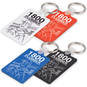 Four keytags in red, blue, black, and white, featuring a cartoon plumber illustration and a ring for attachment.