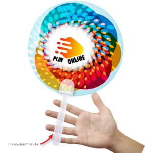 A circular fan featuring vibrant colours and a transparent handle. The centre has a design with playful graphics.