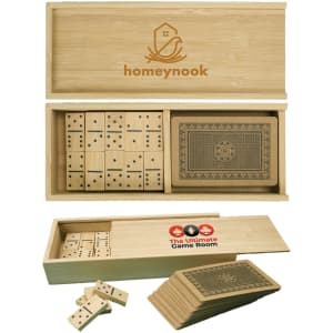 A wooden box containing dominoes and a deck of cards, all in a natural bamboo finish, with a logo on the lid.