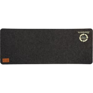 A dark grey desk mat with a textured surface and a circular logo in the corner.