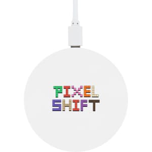 A round wireless charger featuring a white surface with the text "PIXEL SHIFT" displayed in colorful, pixelated letters.