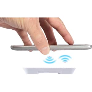A wireless charger with a hand positioning a smartphone above it, indicated by wireless signal symbols.