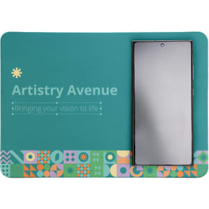 A teal mouse pad with a geometric design, featuring a smartphone placed on it, and a logo at the top.