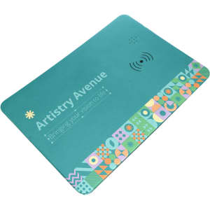 A turquoise wireless charger and mouse pad with a colorful geometric design along one edge and a logo.