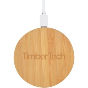 A round bamboo wireless charger in natural wood finish, featuring a logo and connected to a white charging cable.