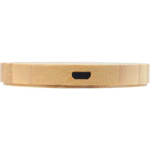 A round bamboo wireless charger with a sleek, natural finish and a black charging port on the side.