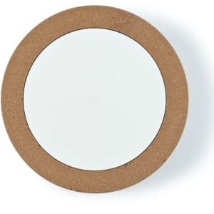 A wireless charger with a round cork exterior and a smooth white charging surface.