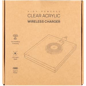 A clear acrylic wireless charger in a cardboard box, featuring a circular charging pad and a Type-C power connection.