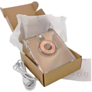 A crystal wireless charger in a box, featuring a copper charging pad, USB cable, and tissue paper.