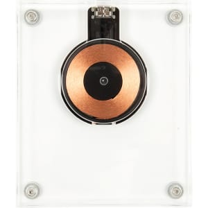 A crystal wireless charger with a clear casing and a circular copper charging pad in the centre.