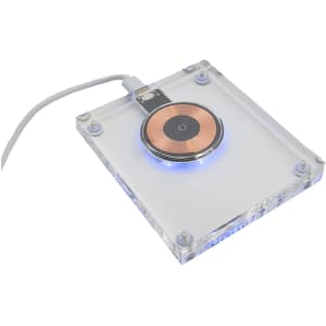 A crystal-clear wireless charger features a circular charging pad with a copper center and blue lighting.