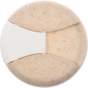 A reusable coffee cup featuring a natural cork band and a light tan-colored body with speckles. It has a logo.