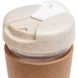 A reusable coffee cup featuring a cork band, with a lid made from a sustainable material that has a speckled design.