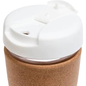 A reusable coffee cup featuring a cork band and a white lid with a sipping opening.