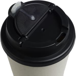 A reusable coffee cup in a light color with a black comfort lid and a small opening for sipping.