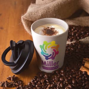 A reusable coffee cup in beige with a black lid, surrounded by coffee beans and cinnamon sticks. It features a logo.