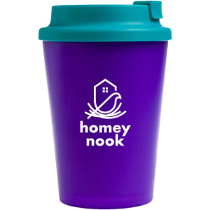 A reusable coffee cup with a purple body and a teal comfort lid, featuring the logo "homey nook" on the front.
