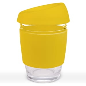 A reusable coffee cup with a clear glass body and a bright yellow silicone lid and sleeve. Features a logo.
