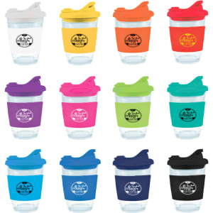 A collection of reusable coffee cups in various colours, featuring snap lids and branding on each cup.