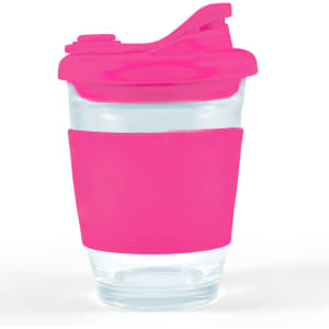 A reusable coffee cup with a transparent glass body, a bright pink silicone sleeve, and a matching snap lid.