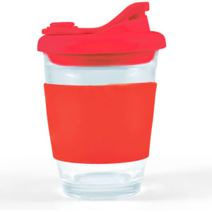 A reusable coffee cup with a clear body and a vibrant red snap lid, featuring a matching silicone sleeve for grip.