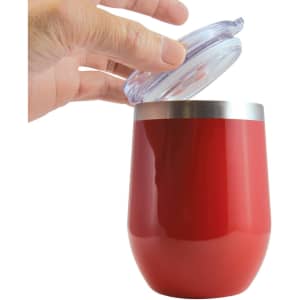 A reusable coffee cup in bright red with a silver rim and a clear lid being partially opened.