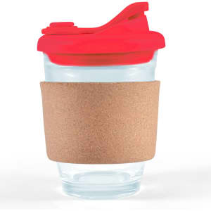 A clear coffee cup with a red snap lid and a cork band around its middle. It has a logo.