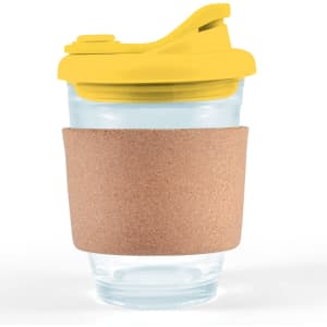A reusable coffee cup featuring a transparent design, a yellow snap lid, and a cork band for grip.