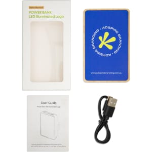 A blue power bank with a logo, accompanied by a user guide and a USB cable, in a product box.