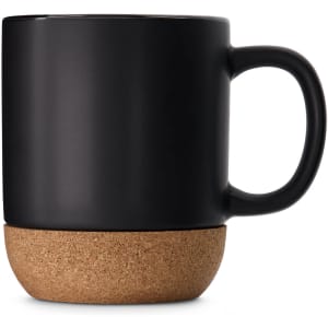 A ceramic mug with a matte black finish and a cork base. It features a single handle and branding.