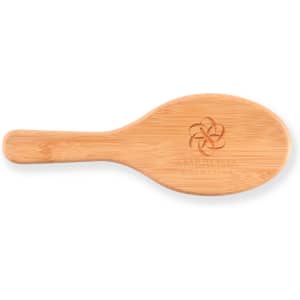 A bamboo hair brush with an engraved logo on the handle.