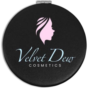A round black compact mirror featuring a logo with a profile silhouette and "Velvet Dew Cosmetics" text.