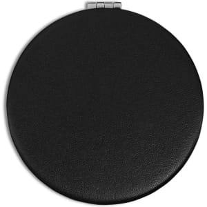 A round, black compact mirror with a textured finish and a silver clasp. It features a logo on the surface.