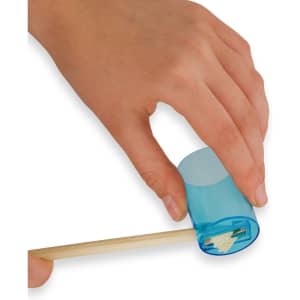 A hand holds a transparent blue tube containing long coloured pencils, with one pencil partially extended.